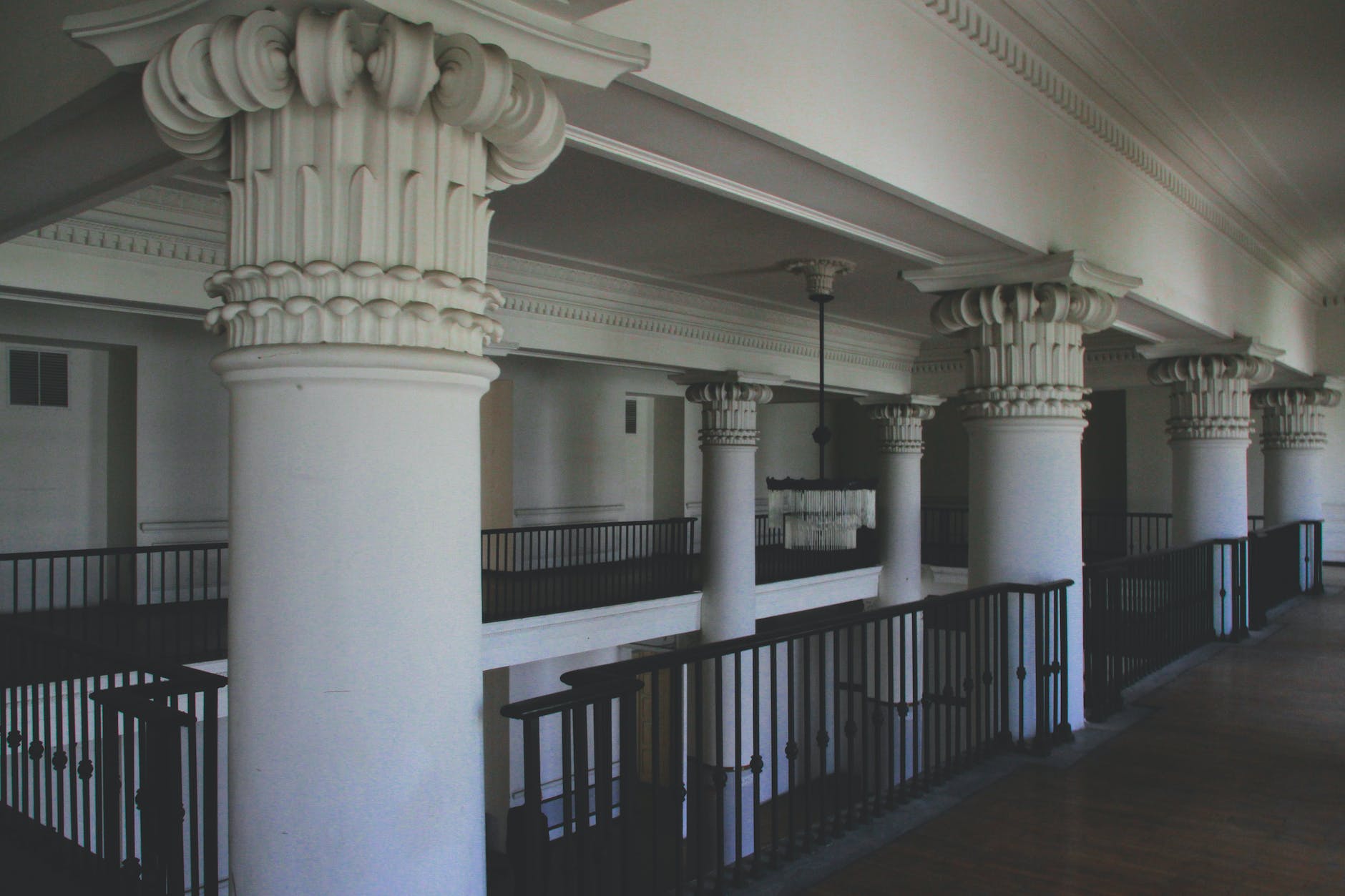 photo of white columns near railings